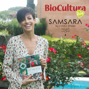 mujer sonriendo y sosteniendo el libro de recetas Programa Crudivegano 21 días Eat Me Raw