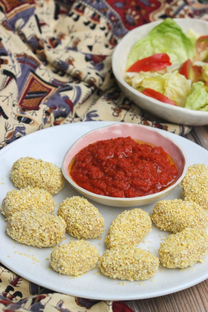 nuggets en un plato con una salsa de tomate en un bol